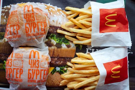 MINSK, BELARUS - February 18, 2018: Burgers and french fries on tray in McDonald's Restaurant. Top view.のeditorial素材