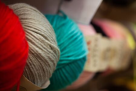 Background with colorful balls of yarn for sale in shop. Selective focus.の写真素材