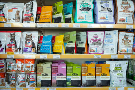 MINSK, BELARUS - June 11, 2020: Food department for pets. Shelving with various types of food for pets inside a supermarket.のeditorial素材