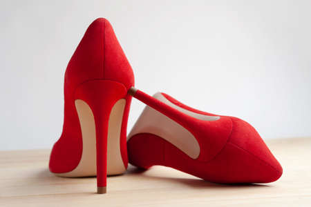 Red female shoes on a wooden floor.の写真素材