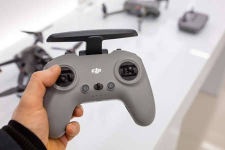 DJI Drone Remote Control in hand. Buyer chooses goods in DJI store. Minsk, Belarus - February, 2022のeditorial素材