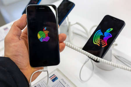 Smartphone Apple iPhone in hand. Buyer choosing smartphone in mobile phones Apple store. Minsk, Belarus - February, 2022のeditorial素材