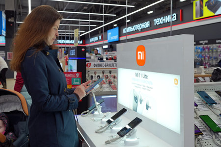 Smartphones Xiaomi shown on display in electronics store. Customer choosing smartphones in mobile phone shop. Minsk, Belarus - may, 2022のeditorial素材