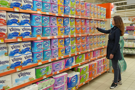 Young woman buying toilet paper rolls at supermarket. Minsk, Belarus - may 2022のeditorial素材