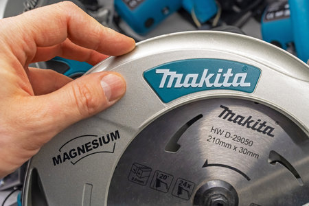A man chooses an electric tool Makita. Makita circular saw. Minsk, Belarus, 2022のeditorial素材