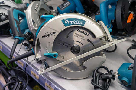 Makita circular saw are sold in the power tool store. Electric hand tool for cutting wood or metal. Minsk, Belarus, 2022のeditorial素材