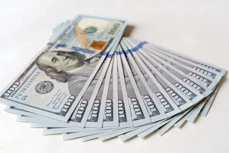 Dollar bills fanned. One hundred us dollars banknotes on white background. Concept for Business,...