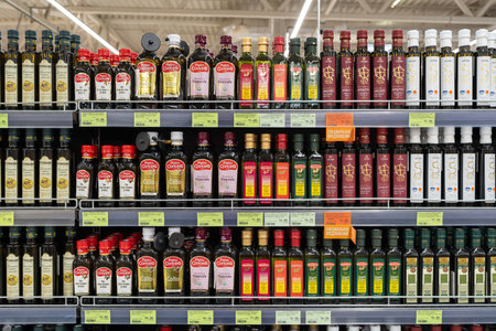 Olive oil of different brands in a grocery store. Large assortment of high quality healthy cooking olive oil. Minsk, Belarus, 2022のeditorial素材