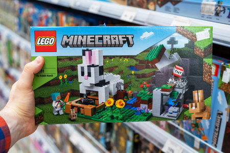 Lego Minecraft constructor in hands of buyer. Lego is a popular line of construction toys manufactured by the Lego Group. Minsk, Belarus, 2022のeditorial素材
