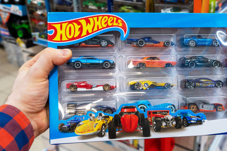 Hot Wheels Kids toys cars in hands of buyer at store. Hot Wheels is a brand scale die-cast toy cars introduced by American toy maker Mattel. Minsk, Belarus, 2022のeditorial素材