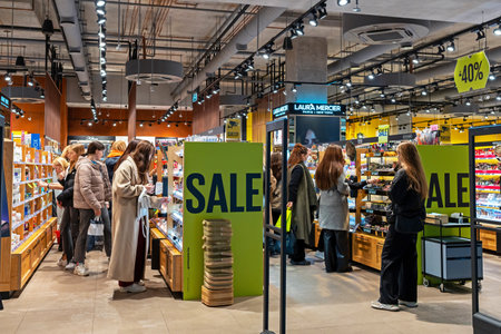 Shop for perfumes and cosmetics of various brands. Shoppers testing cosmetics and choosing goods to...