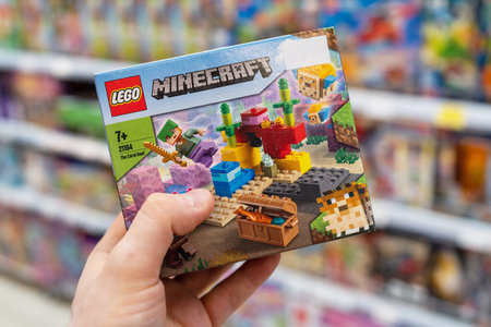 Lego Minecraft constructor in hands of buyer. Lego is a popular line of construction toys manufactured by the Lego Group. Minsk, Belarus, 2022のeditorial素材