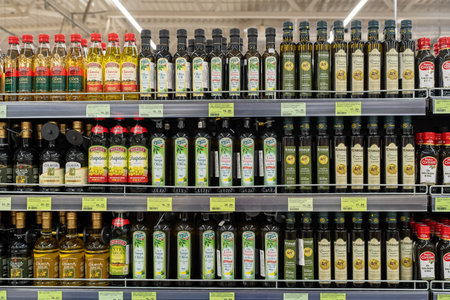 Olive oil of different brands in a grocery store. Large assortment of high quality healthy cooking olive oil. Minsk, Belarus, 2022のeditorial素材