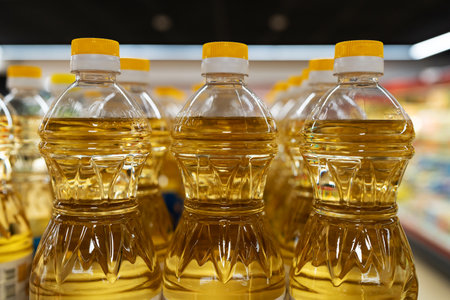 Yellow oil bottles (Soybean oil, Sunflower oil) selling on shelf at supermarket.の写真素材