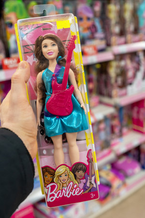 Barbie doll in the hand of a customer in a toy store. Barbie is a fashion doll manufactured by the American toy company Mattel, Inc. Minsk, Belarus, 2022のeditorial素材