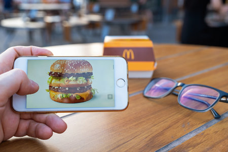 A man looks at the McDonald's website for information about a burger before having lunch. Big Mac...