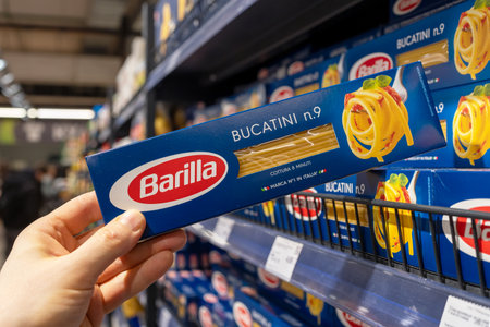 Barilla pasta. A customer takes a package of Barilla pasta from a supermarket shelf. Minsk, Belarus, 2022のeditorial素材