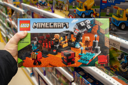 Closeup of Lego box Minecraft in hand of buyer in a toy store supermarket. Minsk, Belarus, 2022のeditorial素材