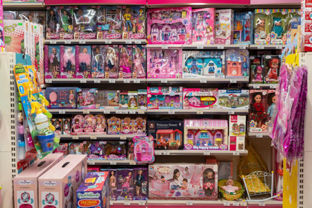 Shelves with dolls for children in a toy store. Large selection of dolls from different manufacturers in the store. Minsk, Belarus, 2023のeditorial素材
