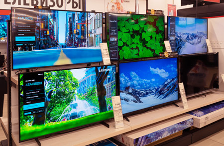 Televisions of different brands on the shelves at the consumer electronics store. Minsk, Belarus, 2023のeditorial素材