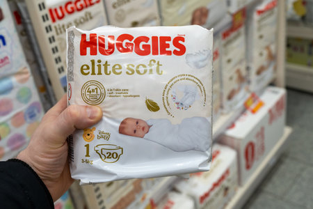 Huggies Diapers for sale in a store. The customer takes a pack of diapers from the store shelf....