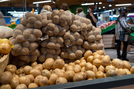 Closeup of fresh organic harvest potatoes on the supermarket shelfの写真素材