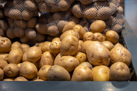 Closeup of fresh organic harvest potatoes on the supermarket shelfの写真素材