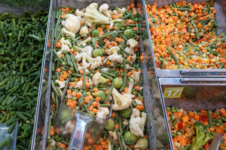 Frozen vegetables. Selling frozen vegetables in the fridge of a grocery store. Frozen foods on...