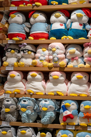 Plush toys for kids on the shelves in Miniso Brand Store. A bright display case with children's toys in a store. Minsk, Belarus - December 16, 2025のeditorial素材