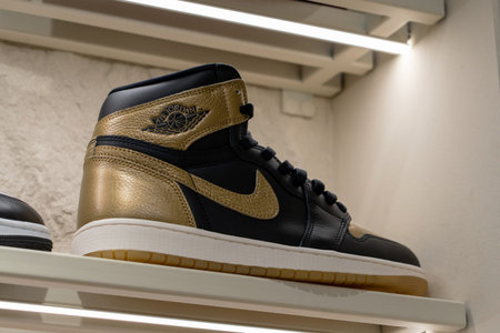 Air Jordan 1 Retro High OG Black and Gold sneaker on display shelf at Nike brand store. Minsk,...