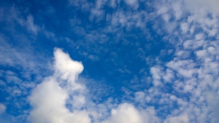 Blue daylight summer sky with fluffy white clouds as nature background.の写真素材