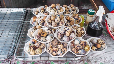 Quail eggs in White box and fish sauce.の写真素材