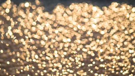 Bokeh golden lights on background (gold, sand)の写真素材