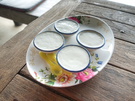 coconut milk custard in small porcelain cup, close upの写真素材