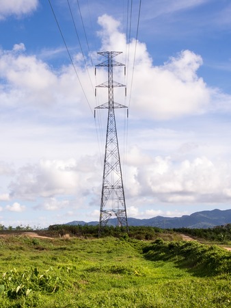 Transmission towers on the grass against the sky with very Quesada.の写真素材