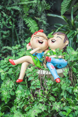 Boy girl doll as decoration in the gardenの写真素材