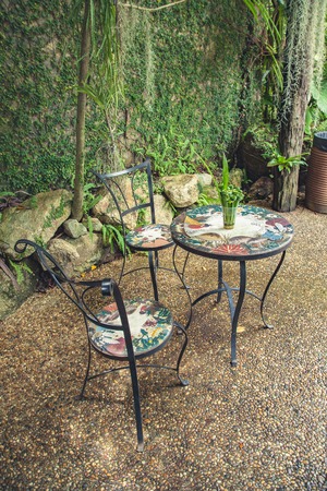 Wrought iron chairs in the gardenの写真素材