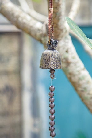 Ancient bell on the background branches.の写真素材