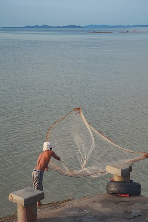 Phuket, Thailand - July 17: Fishermen casting fishing sea Laem Hin on low tide. Phuket, Thailand.のeditorial素材