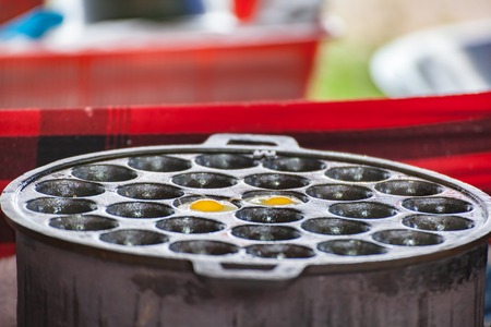 Quail eggs frying on the stove sphere.