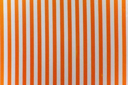 Orange and white vertical stripes textured fabric Background that is seamless and repeats.の写真素材