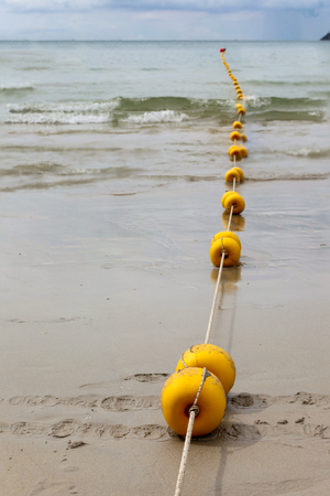 Line of anchor buoys  the sea and a wave in Patong Beach, Phuket,Thailandの写真素材
