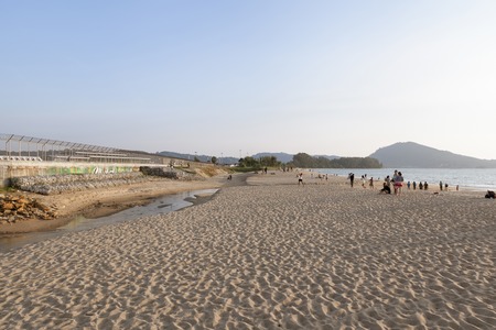 Phuket, Thailand - January 31, 2016: Bathers walking through the high surf and big waves in the Andaman Sea at Mai Khao Beach Phuket, Thailand  January 31, 2016のeditorial素材