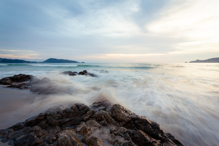 Beautiful  sunset at the rock beach at Patong beach , Phuket island, Thailandの写真素材