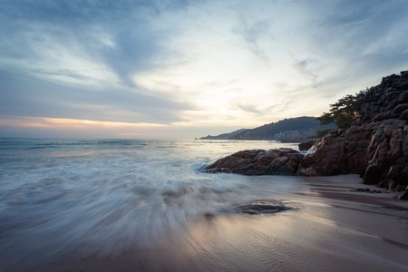 Beautiful  sunset at the rock beach at Patong beach , Phuket island, Thailandの写真素材