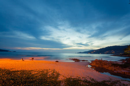 Beautiful  sunset at the rock beach at Patong beach , Phuket island, Thailandの写真素材