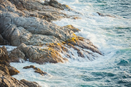 Sea waves crashing against the rocks,Phromthep Cape south of Phuketの写真素材