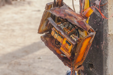 Old rusted electric control box on  pole