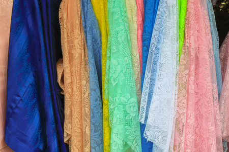Detail of multicolored scarves at a market stand