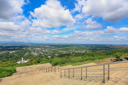 Fluffy cloudy above dramatic blue sky background